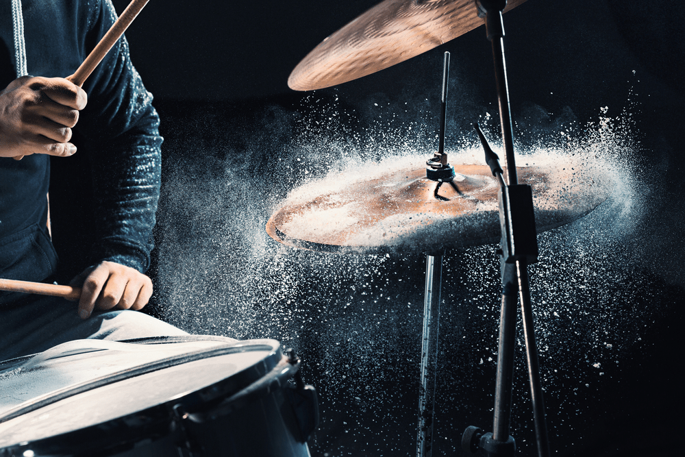 Man recording music on drum set in studio